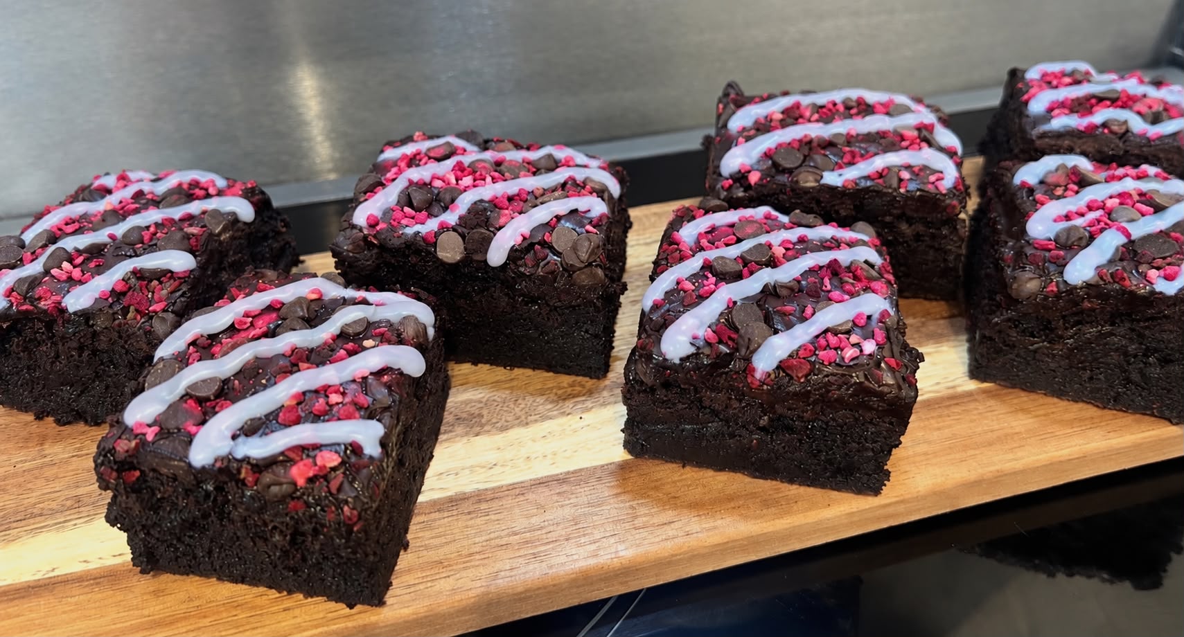 A tray of freshly cut dark chocolate fudge brownies